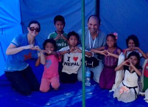 Dr. Farkas poses with children in Nepal