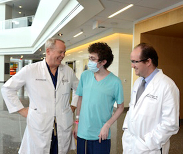 Josiah Ferrell, center, meets with his transplants surgeons, Dr. Michael Wait, left, who performed his lung transplant, and Dr. Malcolm MacConmara, right, who performed the liver transplant.